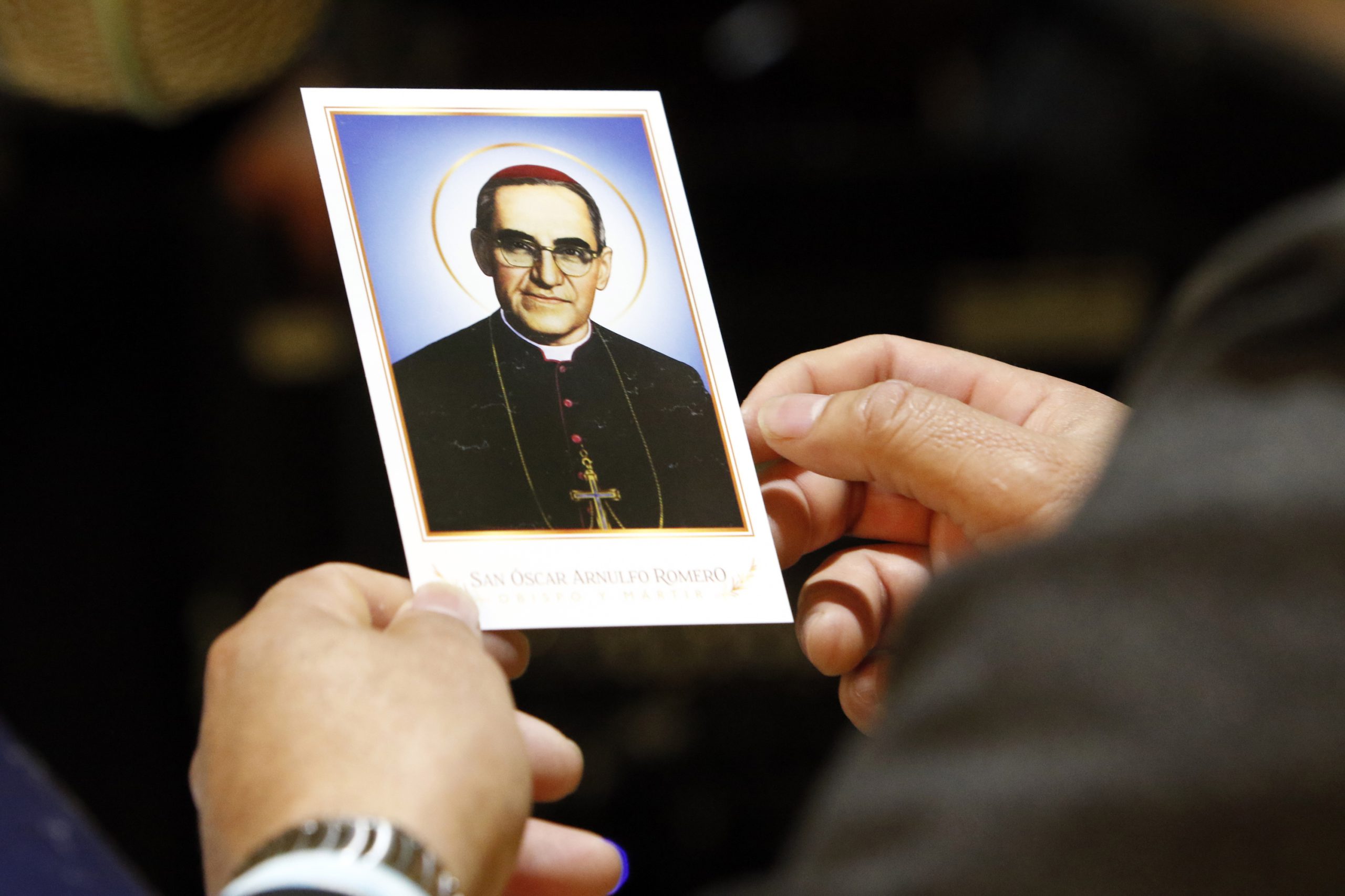A worshipper holds a prayer card of St. Oscar Romero during a Spanish-language Mass Oct. 14 at Our Lady of Loretto Church in Hempstead, N.Y. The parish ministers to one of the largest communities of Salvadoran immigrants in the U.S. and was celebrating the canonization of Salvadoran St. Oscar Romero and six other new saints canonized at the Vatican. (CNS photo/Gregory A. Shemitz)
