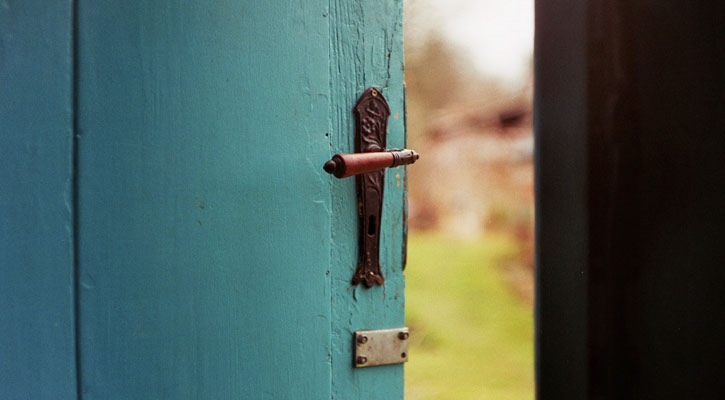 Turquoise door open to the outdoors