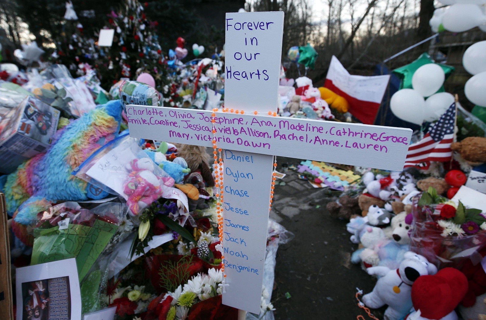 A cross bearing the first names of the victims of the Dec. 14, 2012, shootings at Sandy Hook Elementary School is pictured amid hundreds of other items left by mourners at a memorial in Newtown, Conn., Dec. 19, 2012. Ten years ago a gunman killed 26 people, including 20 children. (CNS photo/Mike Segar, Reuters)