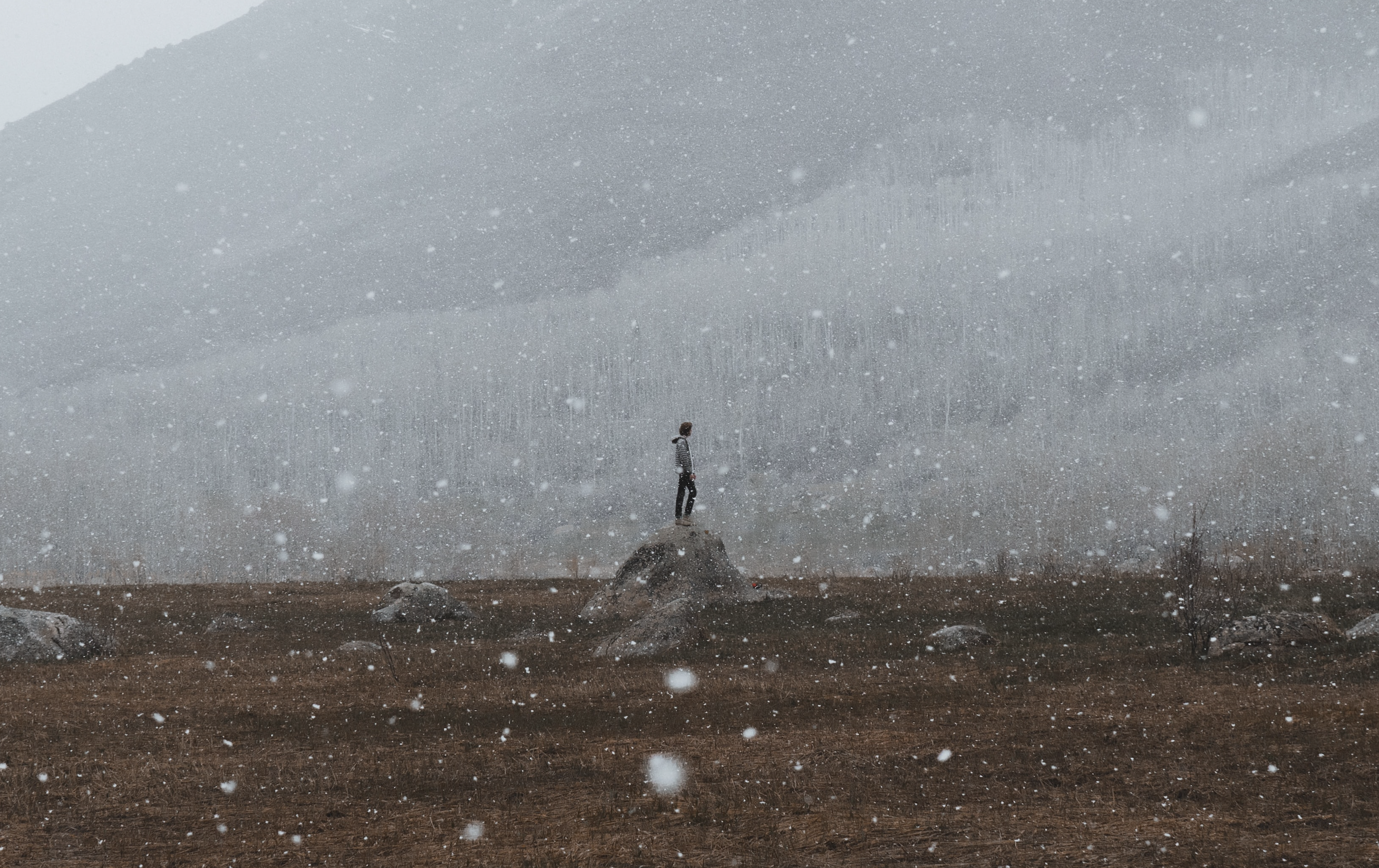 Man standing in a snowy field | Photo by Hunter Bryant on Unsplash