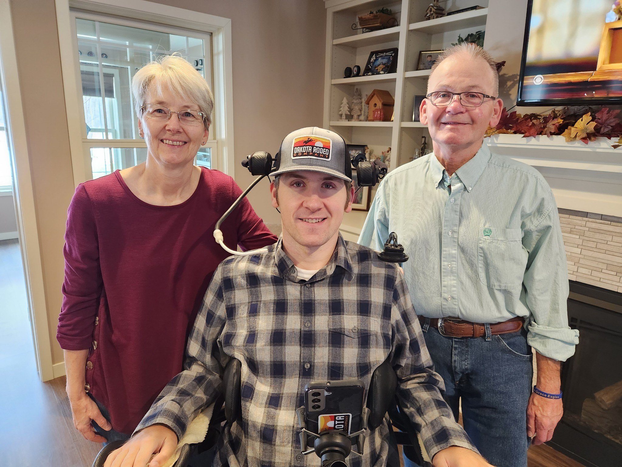 Matt Olson, a native of Isanti, Minn., is pictured with his parents, Doug and Sue Olson, in an undated photo. In February 2016, a junior hockey game left Olson, 20 years old at the time, paralyzed from the chest down. Now 26, Olson credits faith, family, community and his alma mater, Totino-Grace Catholic High School in Fridley, Minn., with carrying him through the many challenges he has faced as a result of his life-altering injury.(OSV News photo/courtesy Matt Olson)