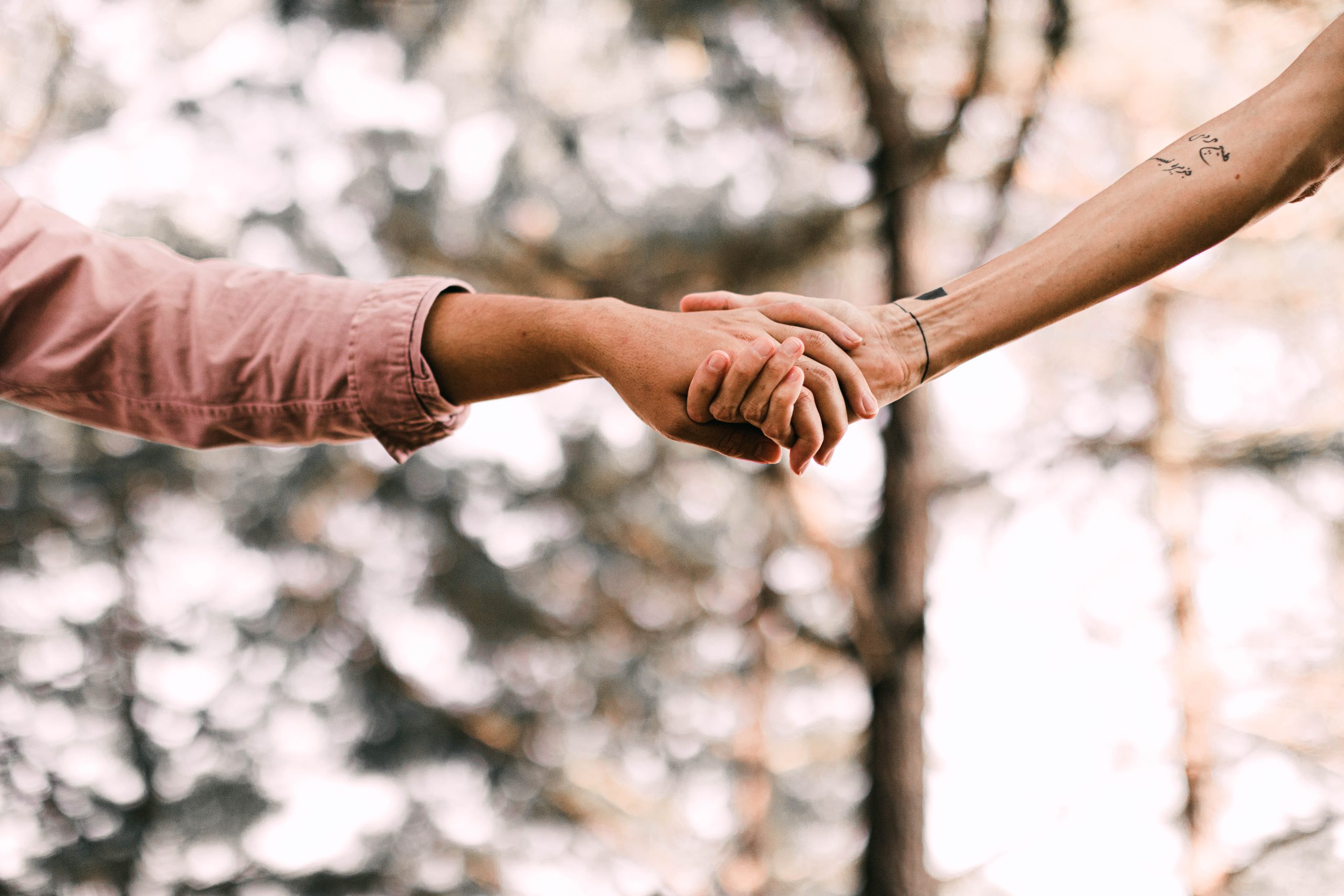 Two people holding hands | Photo by tabitha turner on Unsplash
