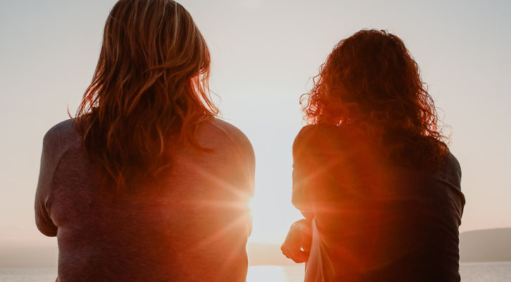 Two women watching sunset