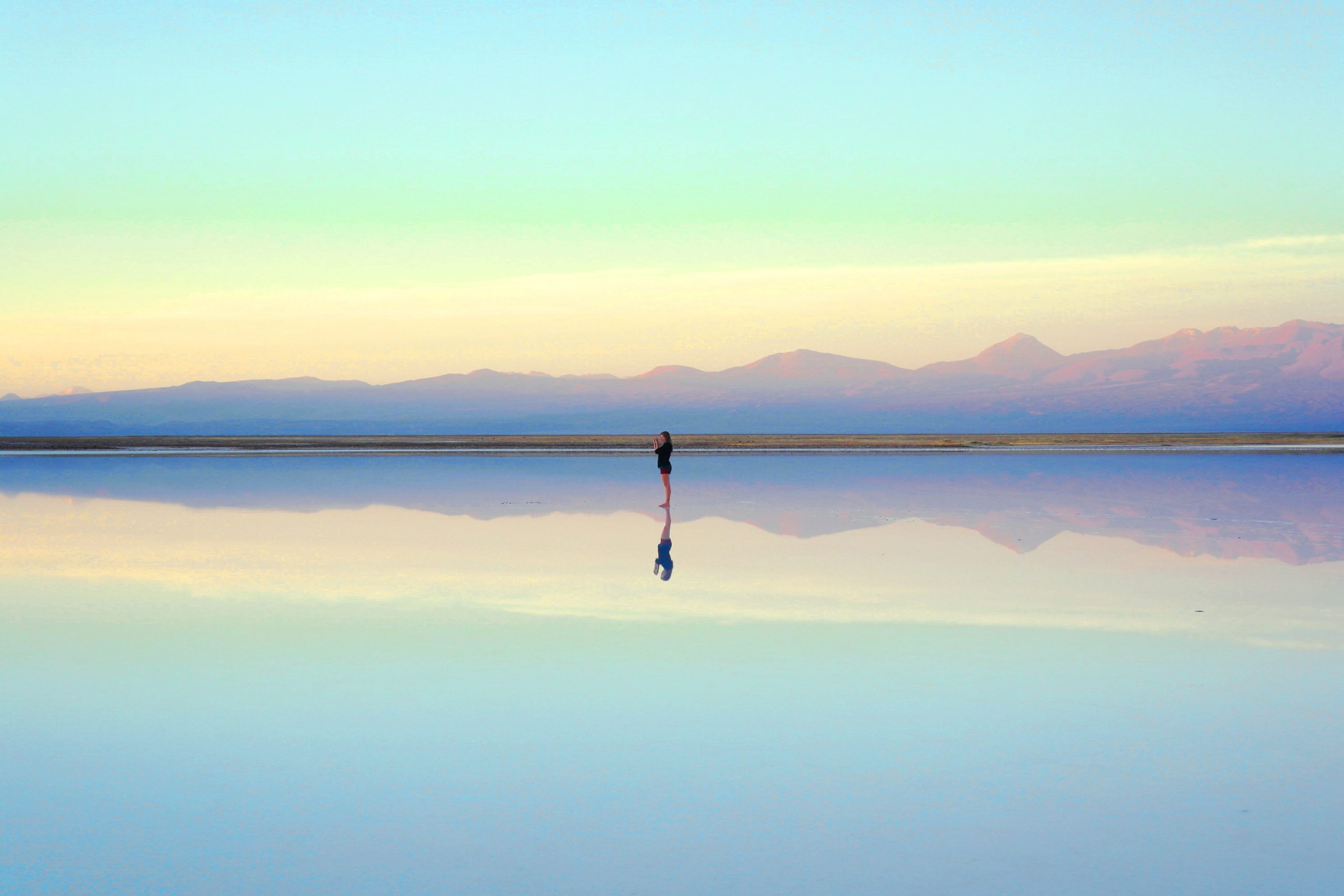 Woman standing near water | Photo by José M. Reyes on Unsplash