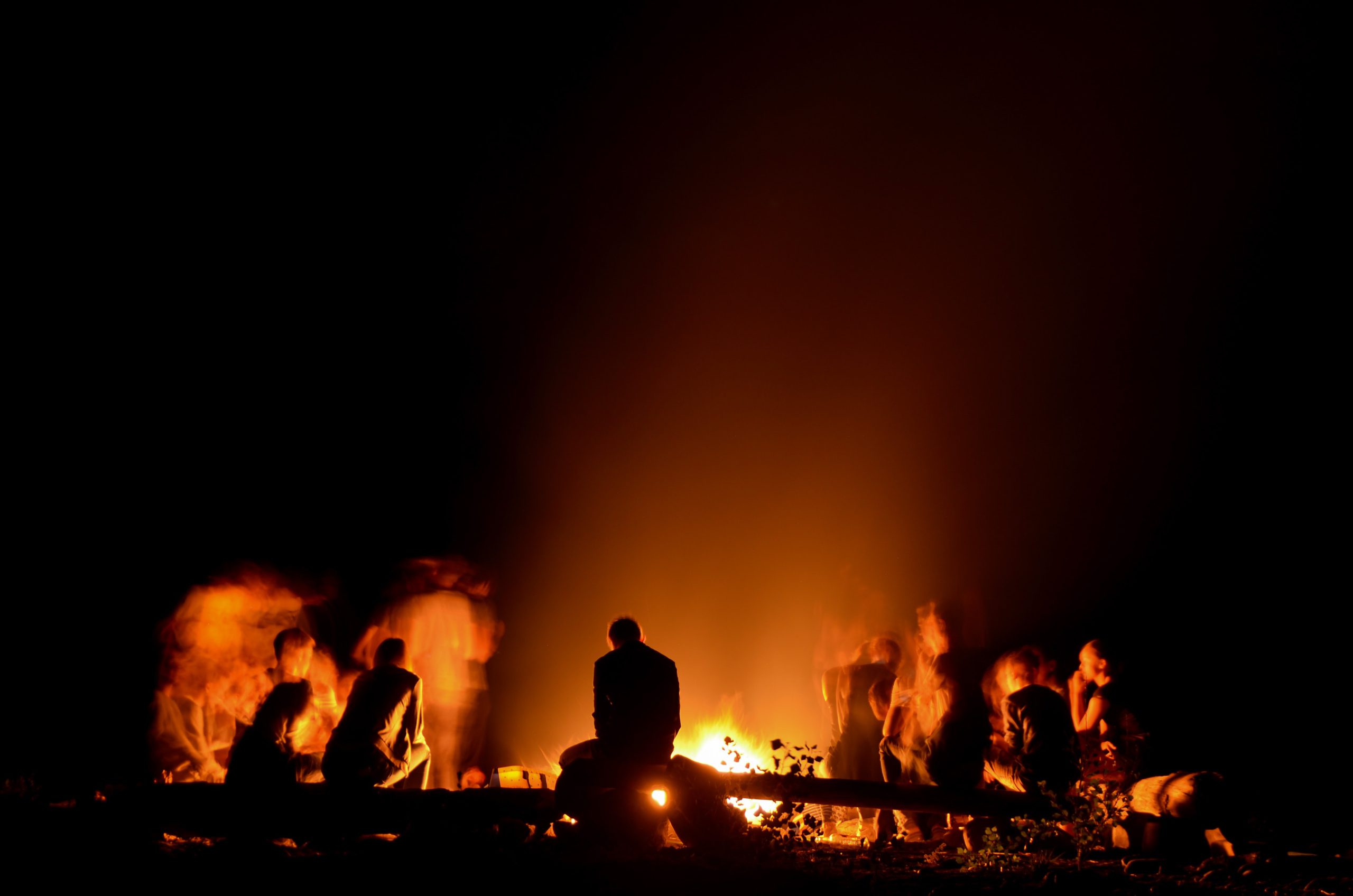 People around a campfire | Photo by Joris Voeten on Unsplash