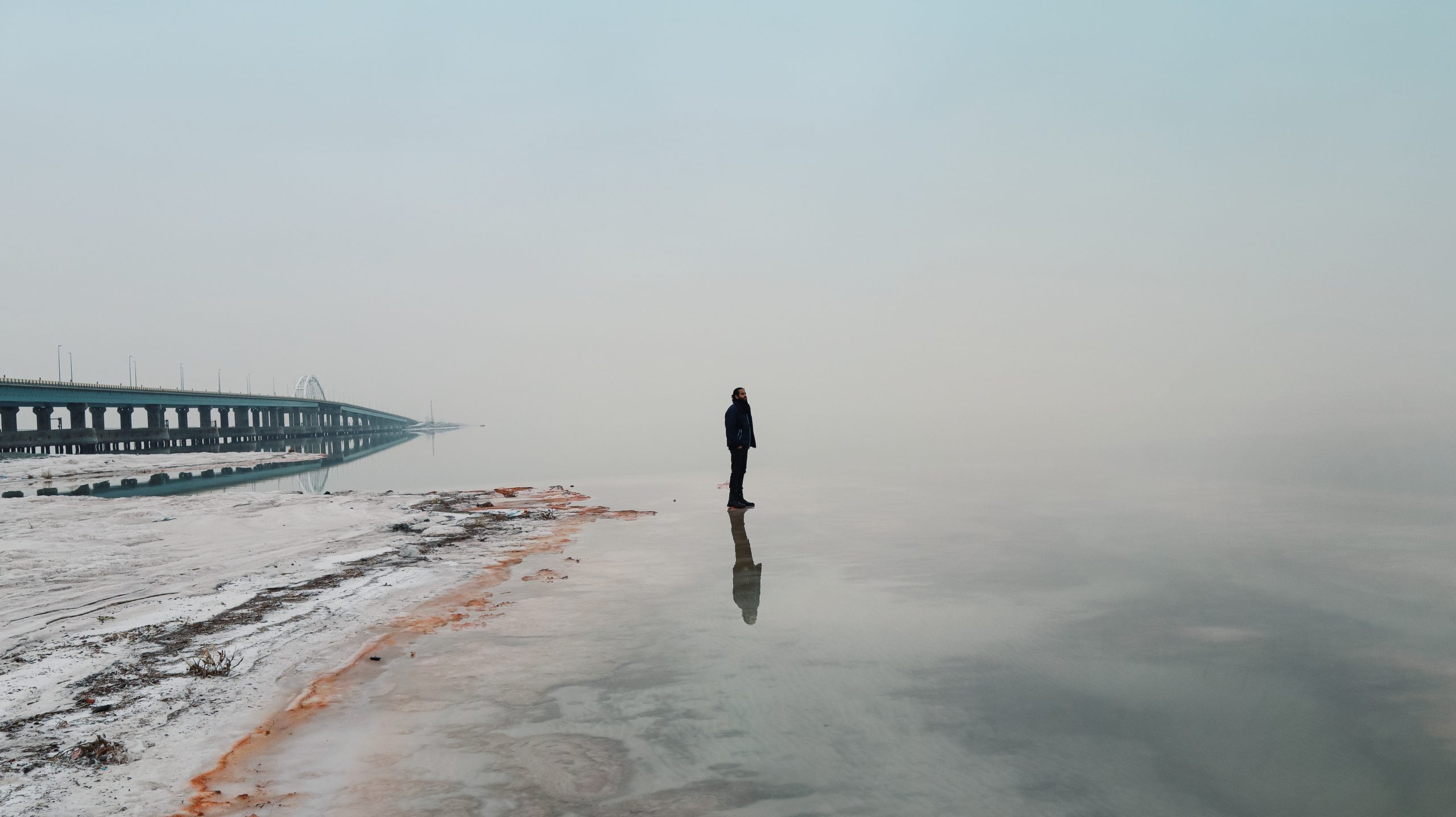 Man on a beach | Photo by Farhad Fallahzad on Unsplash